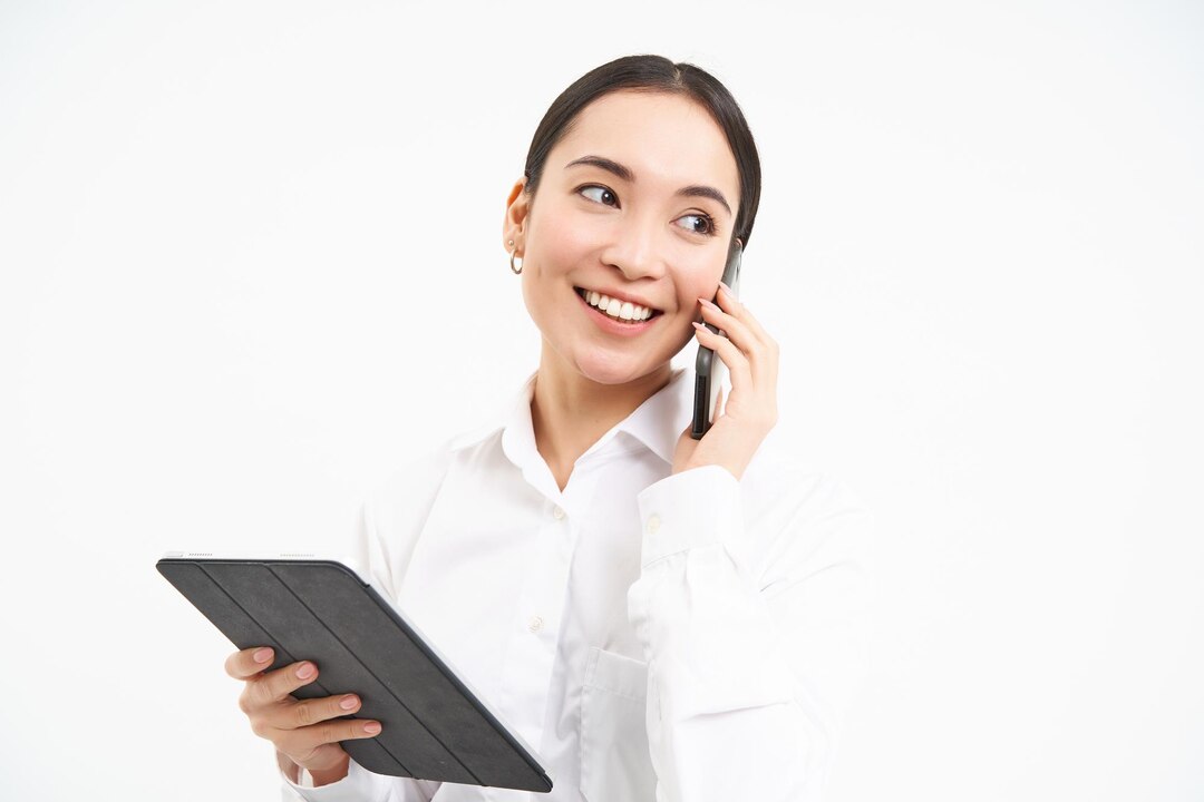 Asian working businesswoman discussing business phone talking cellphone looking d 1258 169538