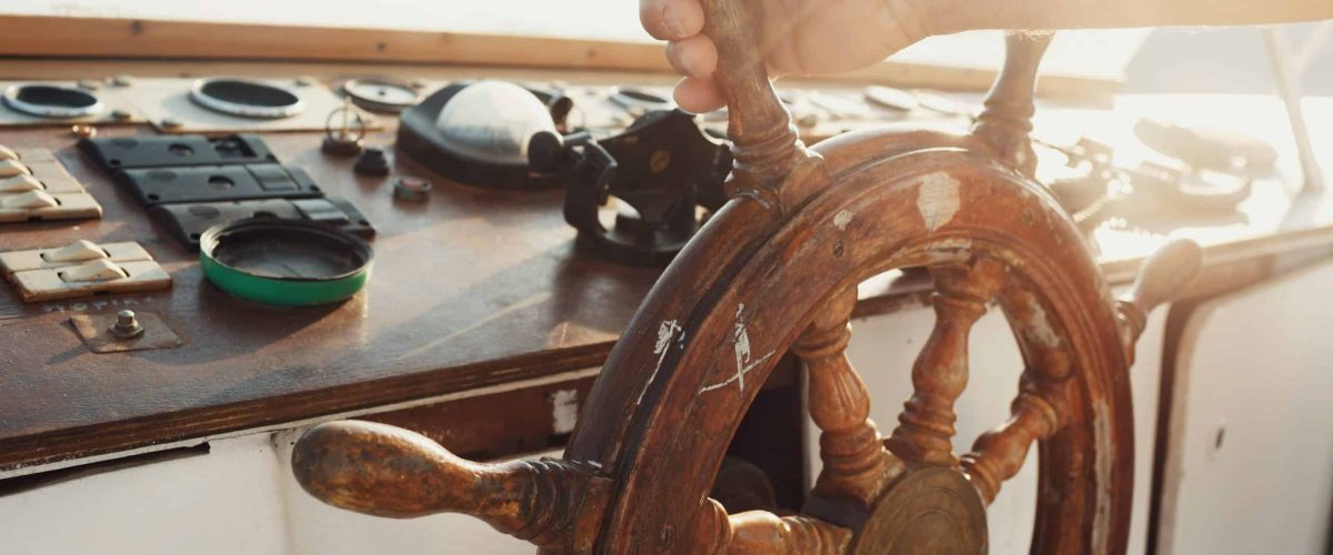 Sun shines wooden wheel held by man scaled 1 1200x500