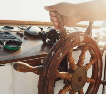 Sun shines wooden wheel held by man scaled 1 360x320